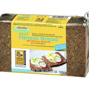 Slice of Mestemacher Low-Calorie Bread on a wooden cutting board, showcasing its hearty texture and whole grain ingredients, ideal for healthy meals and snacks