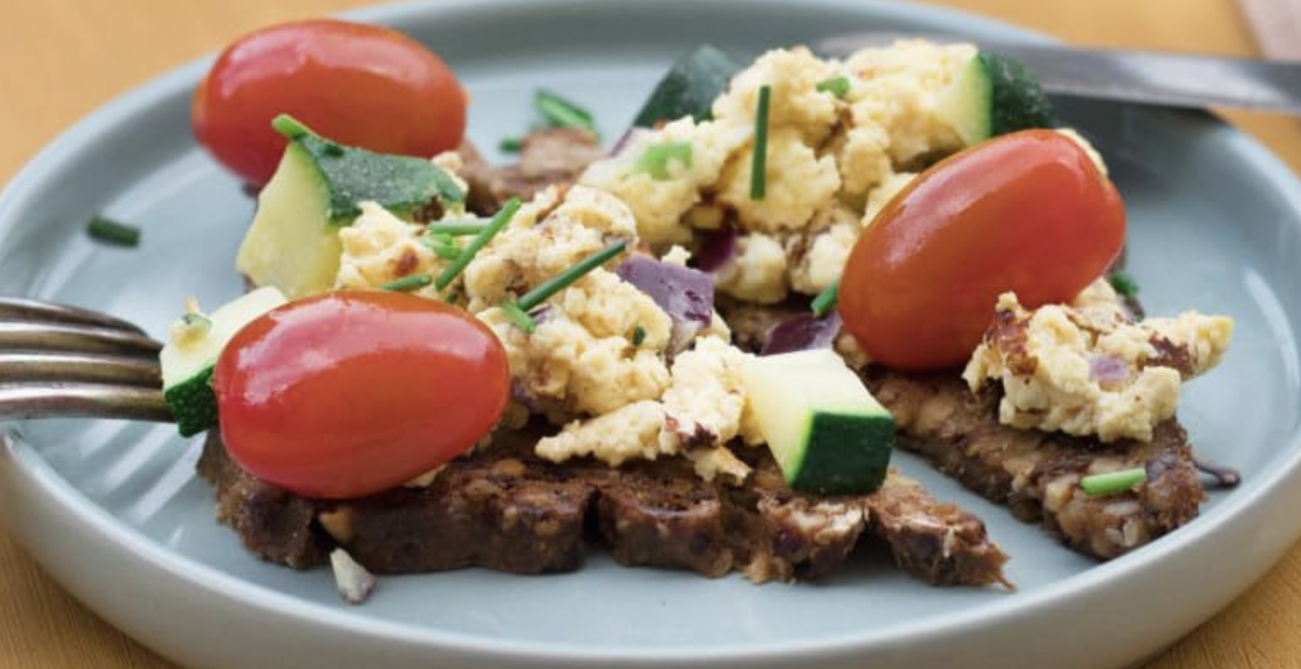 Slice of Mestemacher Low-Calorie Bread on a wooden cutting board, showcasing its hearty texture and whole grain ingredients, ideal for healthy meals and snacks