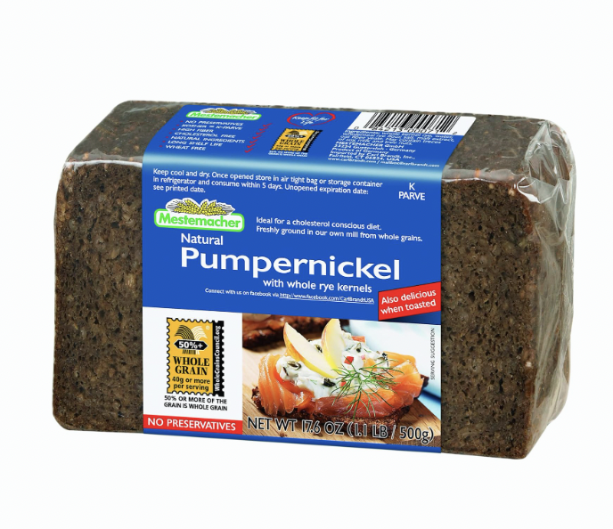 Slice of Mestemacher Low-Calorie Bread on a wooden cutting board, showcasing its hearty texture and whole grain ingredients, ideal for healthy meals and snacks